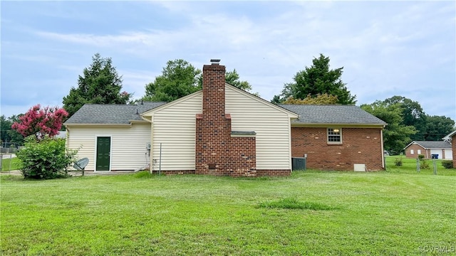 rear view of property with a yard