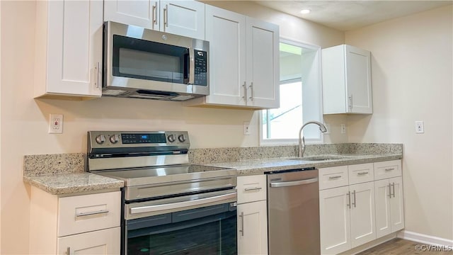 kitchen featuring white cabinetry, sink, and appliances with stainless steel finishes