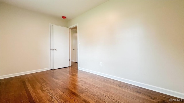 empty room with hardwood / wood-style flooring