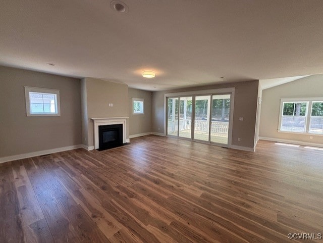 TBD1 Park St, Ashland, VA 23005 - unfurnished living room with dark wood-style flooring, healthy amount of natural light, and a glass covered fireplace