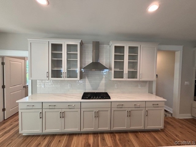 TBD1 Park St, Ashland, VA 23005 - kitchen featuring wall chimney range hood, black gas cooktop, dark wood finished floors, tasteful backsplash, and light countertops
