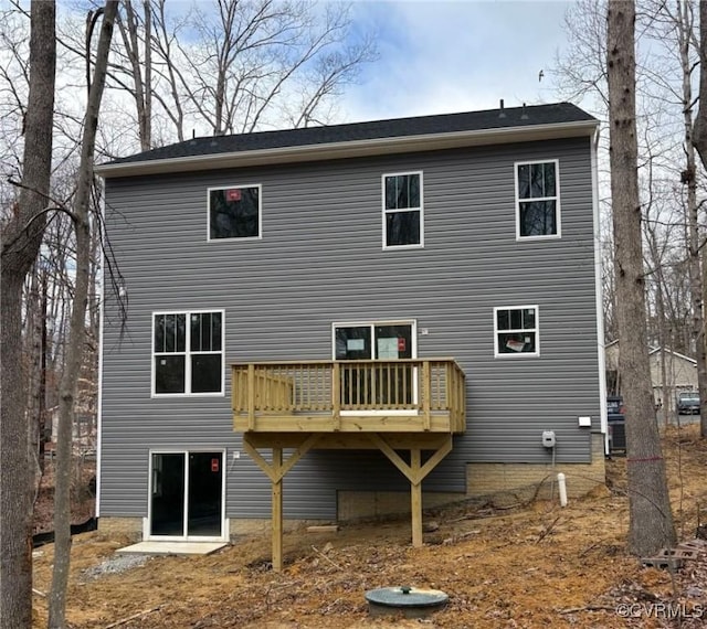 rear view of house featuring a wooden deck