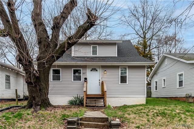 bungalow-style home with a front yard