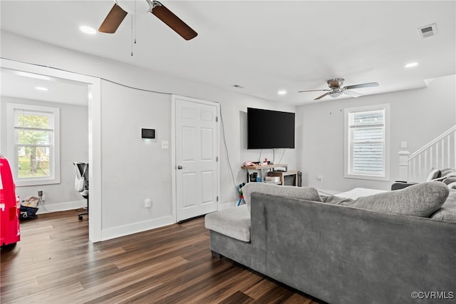 living room featuring dark hardwood / wood-style flooring and ceiling fan