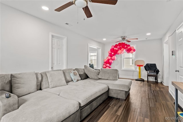 living room with dark hardwood / wood-style flooring and ceiling fan