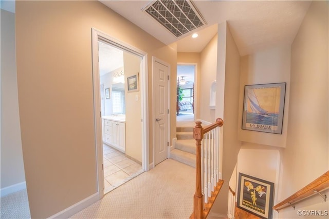 hallway with light colored carpet