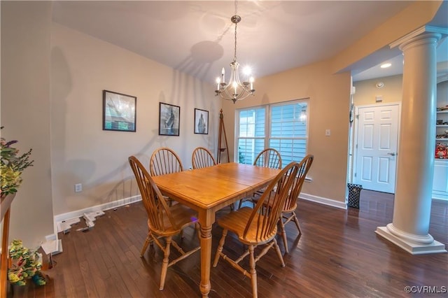 dining room with an inviting chandelier, dark hardwood / wood-style flooring, and decorative columns