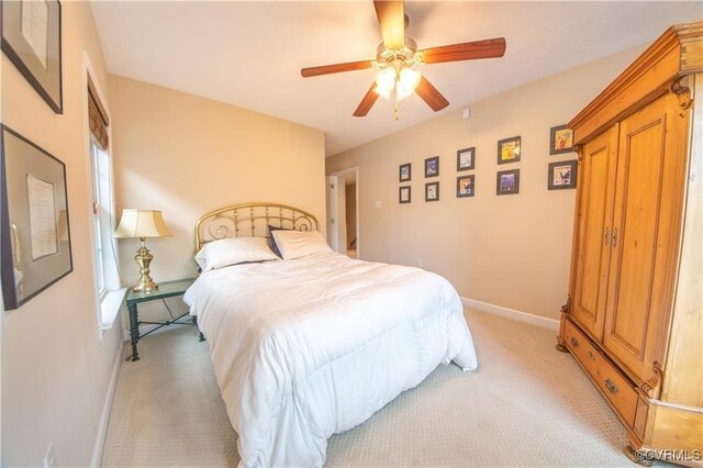 bedroom featuring light carpet and ceiling fan