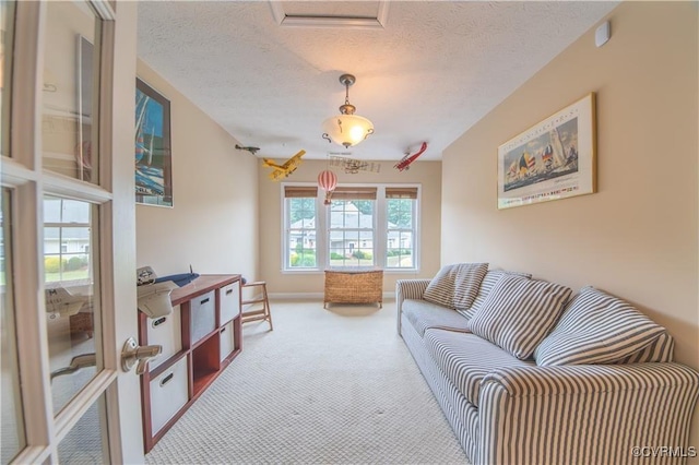 carpeted living room featuring a textured ceiling