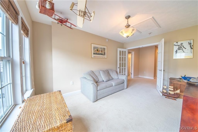 living room featuring carpet, french doors, and a healthy amount of sunlight