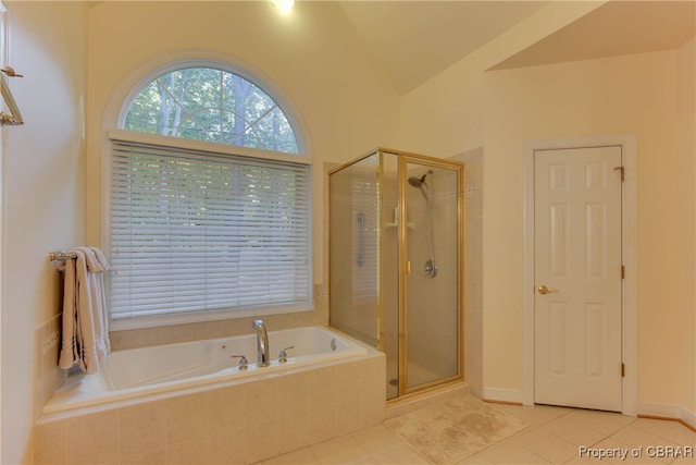 bathroom featuring separate shower and tub, tile patterned floors, and vaulted ceiling