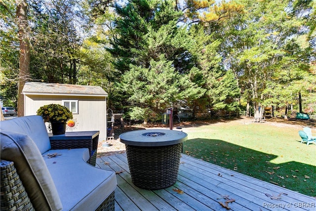 deck featuring a yard and a fire pit