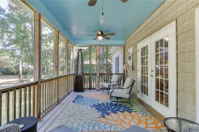 unfurnished sunroom featuring ceiling fan