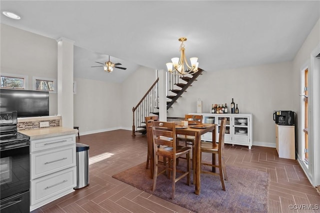 dining area featuring ceiling fan with notable chandelier, vaulted ceiling, and dark parquet floors