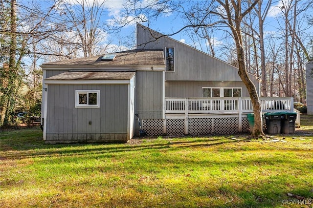 back of house with a yard and a deck