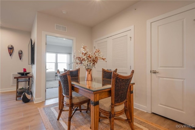 dining space featuring light wood-type flooring