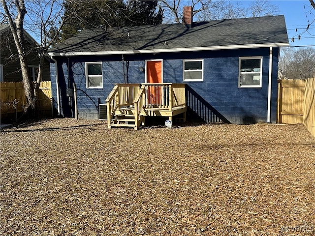 rear view of property with central AC