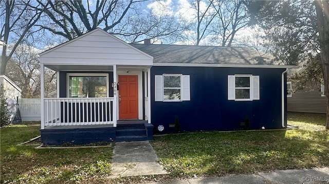 bungalow-style home with covered porch and a front lawn