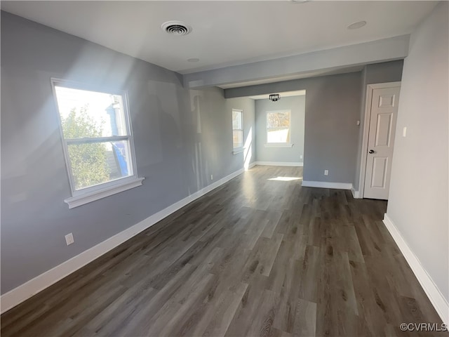 spare room featuring dark wood-type flooring