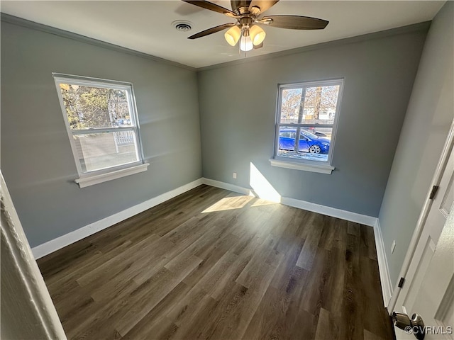 spare room with ornamental molding, dark wood-type flooring, and ceiling fan