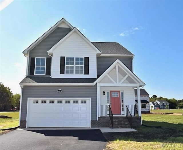 view of front of home featuring a front yard and a garage