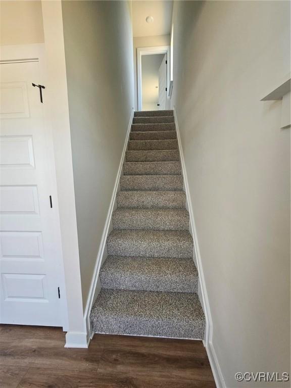 stairs with hardwood / wood-style floors