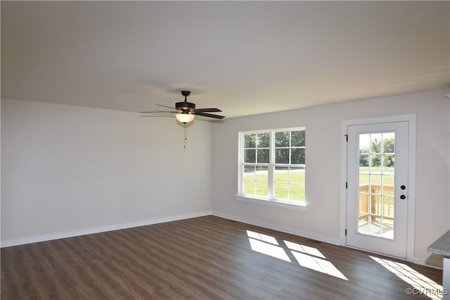 spare room featuring ceiling fan and dark hardwood / wood-style flooring