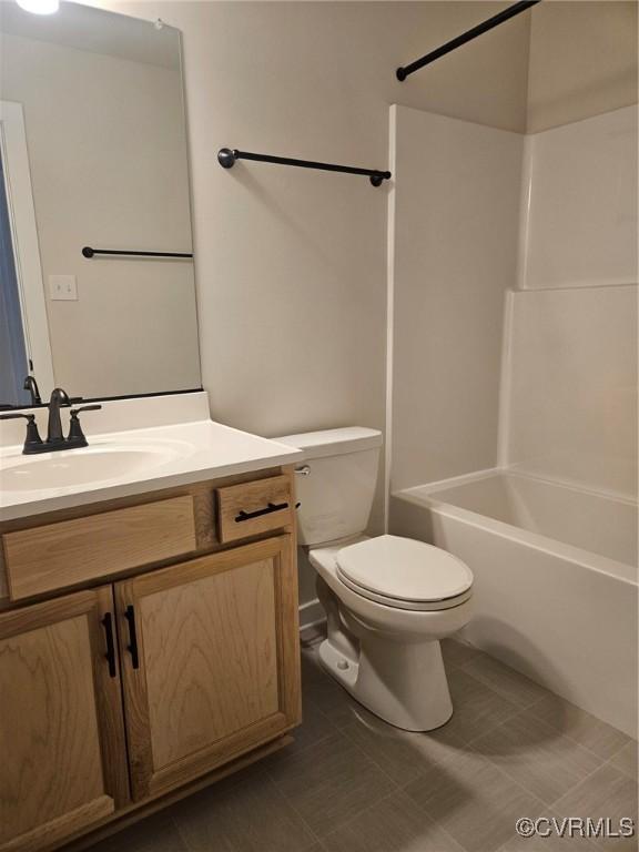 full bath with toilet, tile patterned flooring, bathtub / shower combination, and vanity