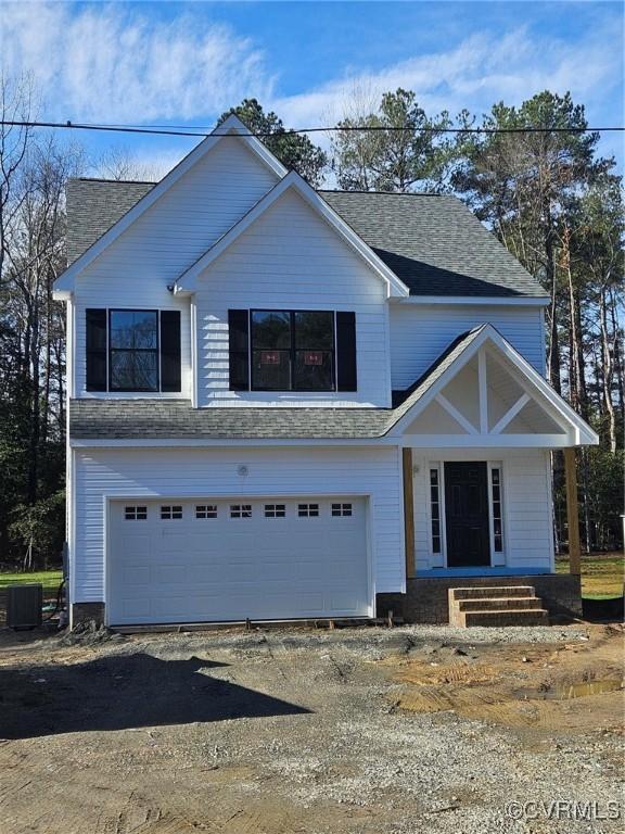 view of front of house featuring a garage, a shingled roof, driveway, and central air condition unit