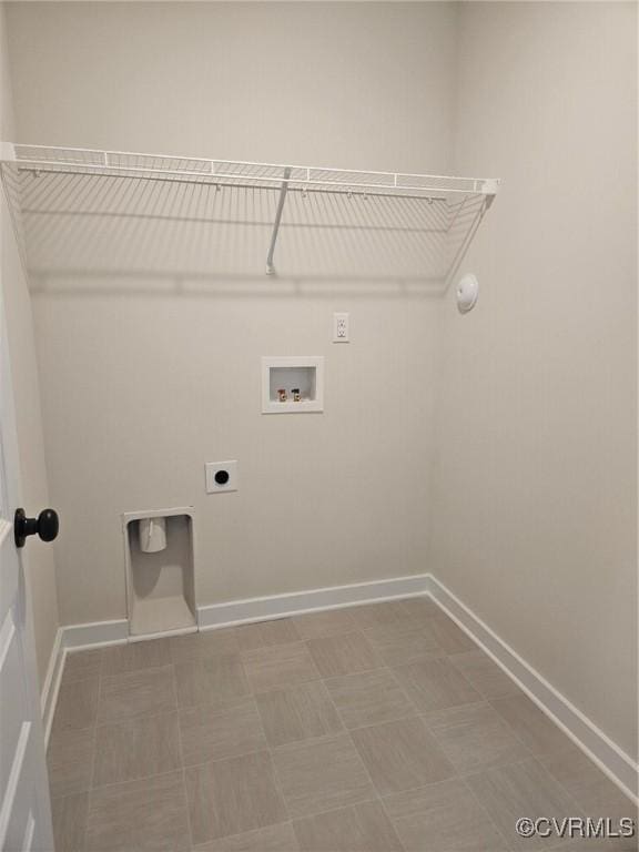 laundry area with tile patterned floors, laundry area, electric dryer hookup, hookup for a washing machine, and baseboards
