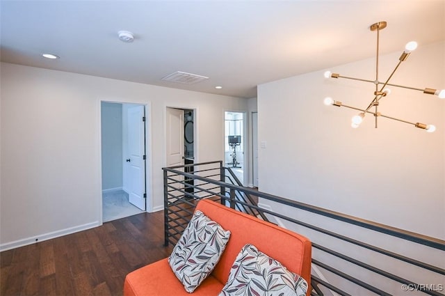 sitting room featuring dark hardwood / wood-style flooring and a notable chandelier