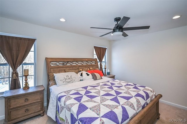 bedroom with ceiling fan and light carpet