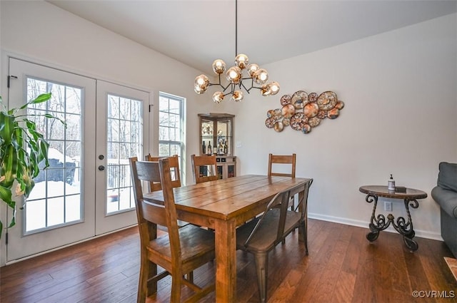 dining space with dark hardwood / wood-style floors and french doors