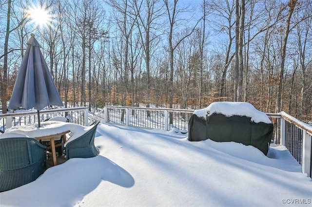 yard covered in snow with a deck