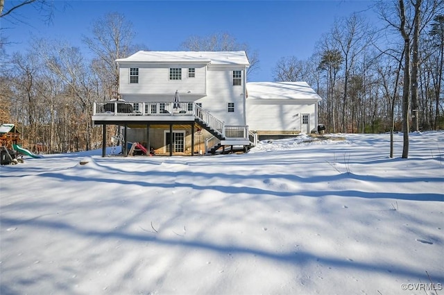 snow covered property featuring a wooden deck