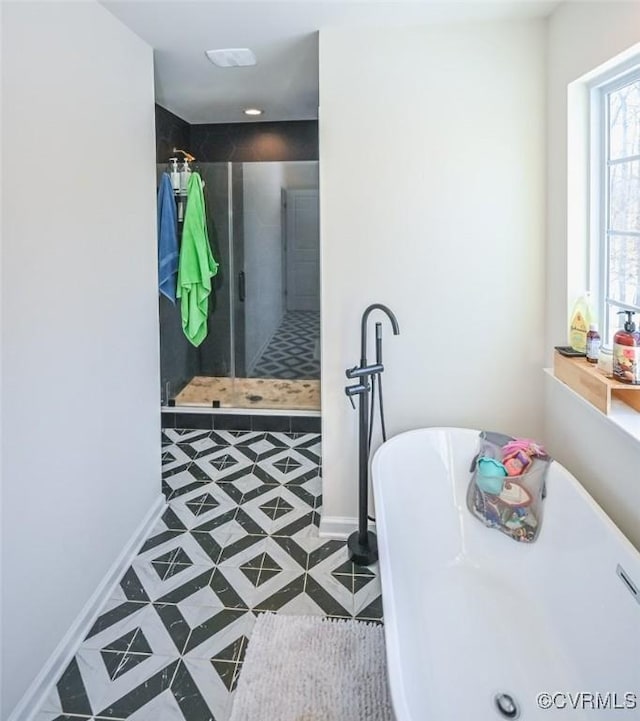 bathroom featuring independent shower and bath and tile patterned flooring