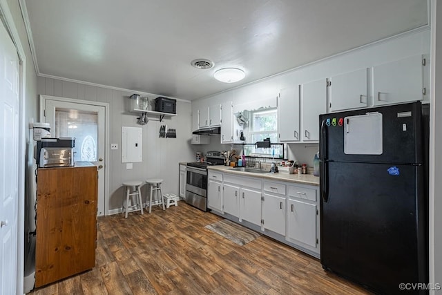 kitchen featuring black refrigerator, sink, electric panel, white cabinetry, and stainless steel range with electric cooktop