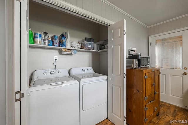 washroom featuring separate washer and dryer, crown molding, and dark wood-type flooring