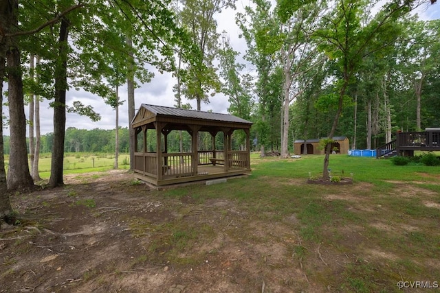 view of property's community with a lawn, a gazebo, and a storage unit