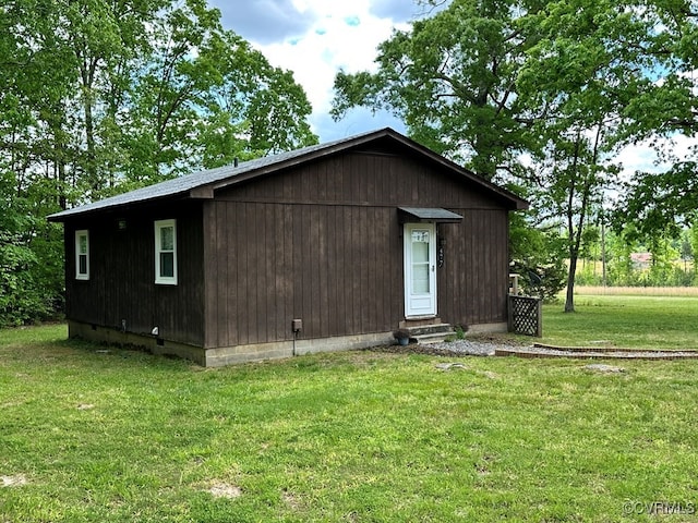 view of outbuilding featuring a yard