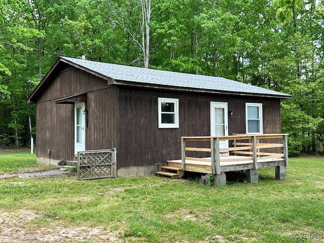 view of outbuilding with a lawn