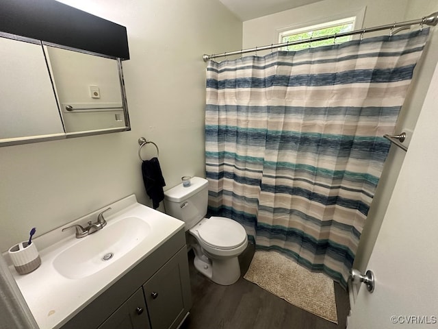 bathroom featuring a shower with curtain, vanity, hardwood / wood-style flooring, and toilet