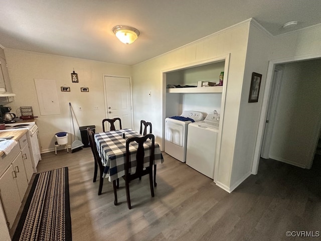 dining area featuring washing machine and dryer, crown molding, dark hardwood / wood-style flooring, and built in shelves