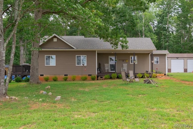 ranch-style home with a garage, an outbuilding, and a front lawn