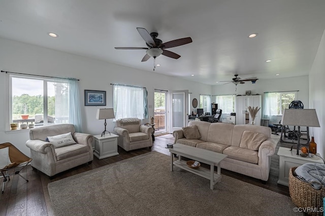 living room featuring dark hardwood / wood-style floors, ceiling fan, and a healthy amount of sunlight