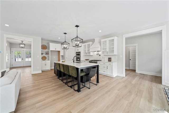 3900 New Kent Hwy, Quinton, VA 23141 - kitchen with custom exhaust hood, white cabinetry, a breakfast bar area, light countertops, and glass insert cabinets