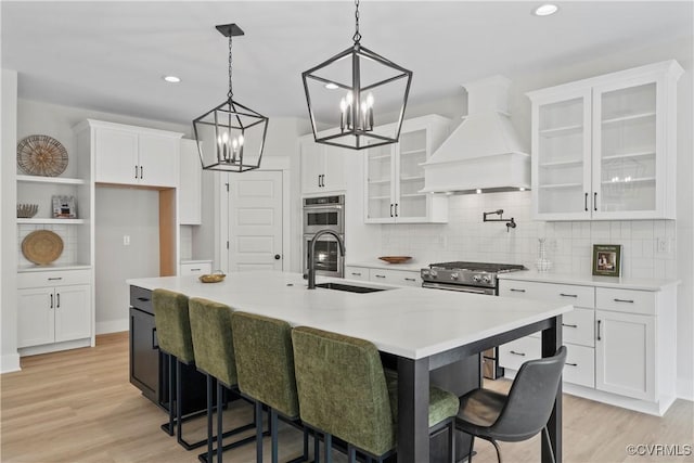 3900 New Kent Hwy, Quinton, VA 23141 - kitchen with a sink, stainless steel appliances, premium range hood, a chandelier, and white cabinets