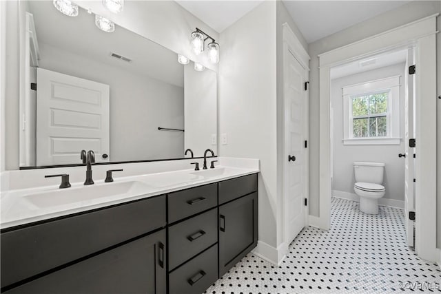 3900 New Kent Hwy, Quinton, VA 23141 - full bathroom featuring baseboards, toilet, and double vanity