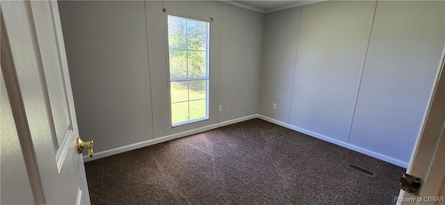 carpeted empty room featuring crown molding