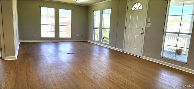 entryway with dark hardwood / wood-style floors and ornamental molding